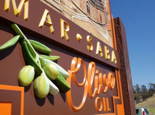 Routed sandblasted sign for olive oil company