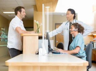 Customer service staff and customer using Sneeze Guard Safety Screen