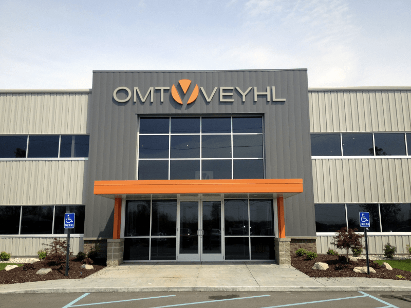 Stud-mounted painted metal letters.