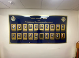 Large acrylic sign with mounted frames and engraved plaques with standoffs