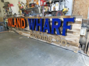 Inland Wharf Illuminated Channel Letters on Distressed Wood Backer