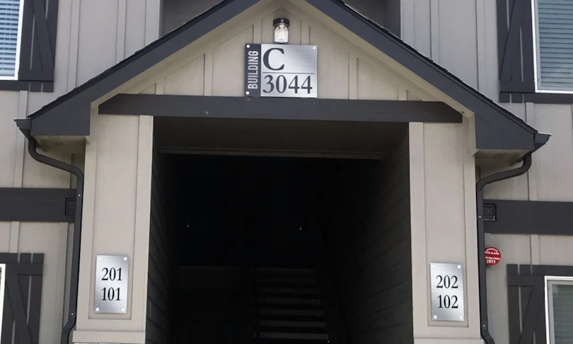 Brushed Aluminum sign panels mounted with standoffs for building identification