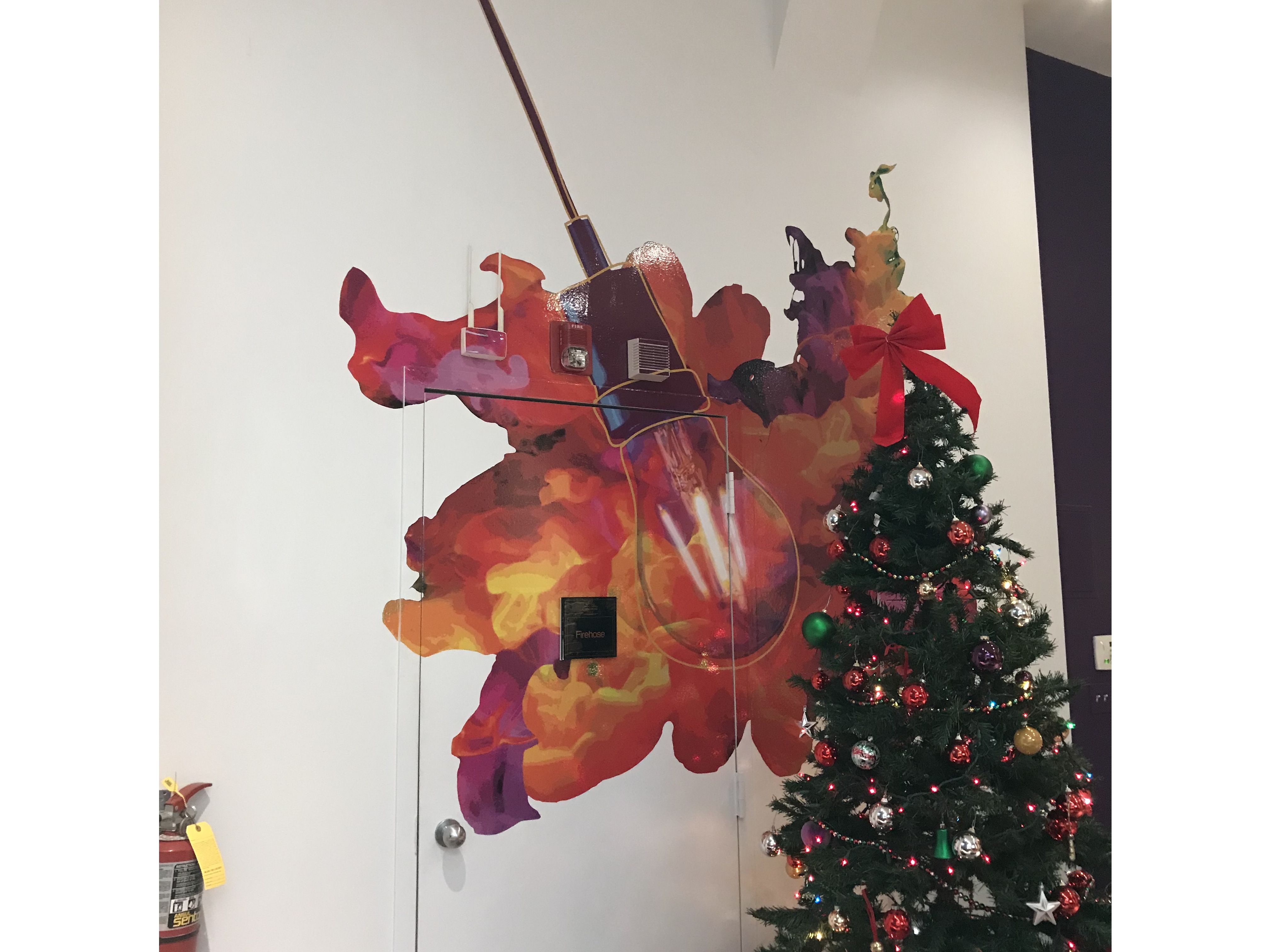 Colorful cut to shape wall graphic applied over doorway at CBD Marketing in the Chicago Loop