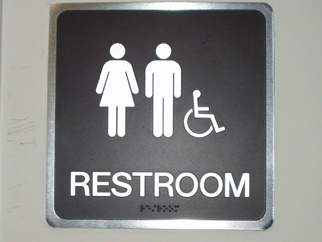 Black and silver Restroom Sign