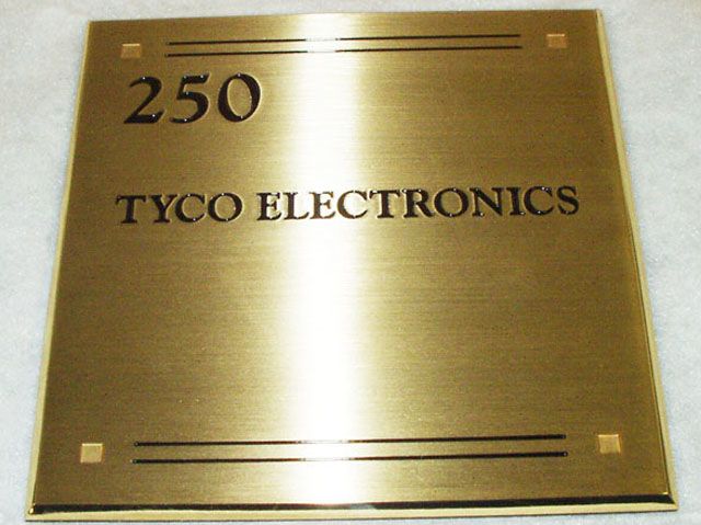 Egraved and paint filled text on brass plaque