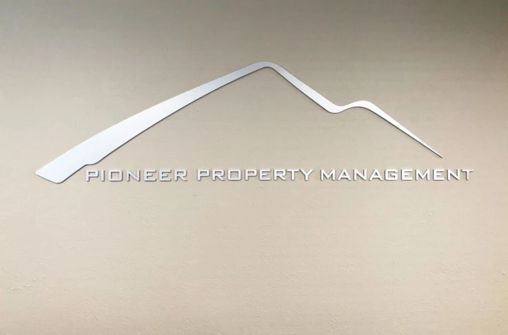 Brushed silver wall logo