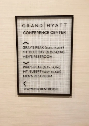 Acrylic signage with raised lettering, custom weave background and acrylic frame