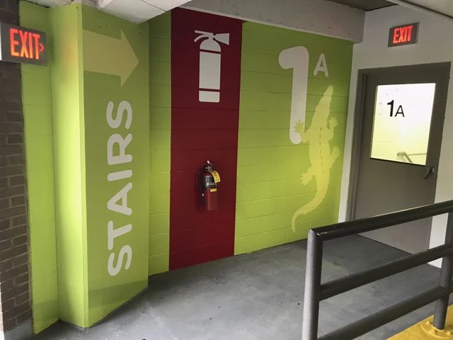 Full color wayfinding graphics applied to masonry surface