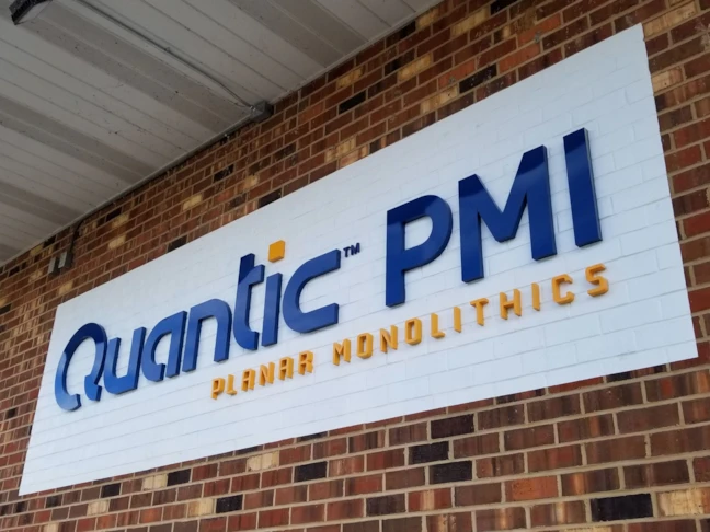 Fabricated Steel Dimensional Logo with White Vinyl Applied to Brick for Contrast & Texture